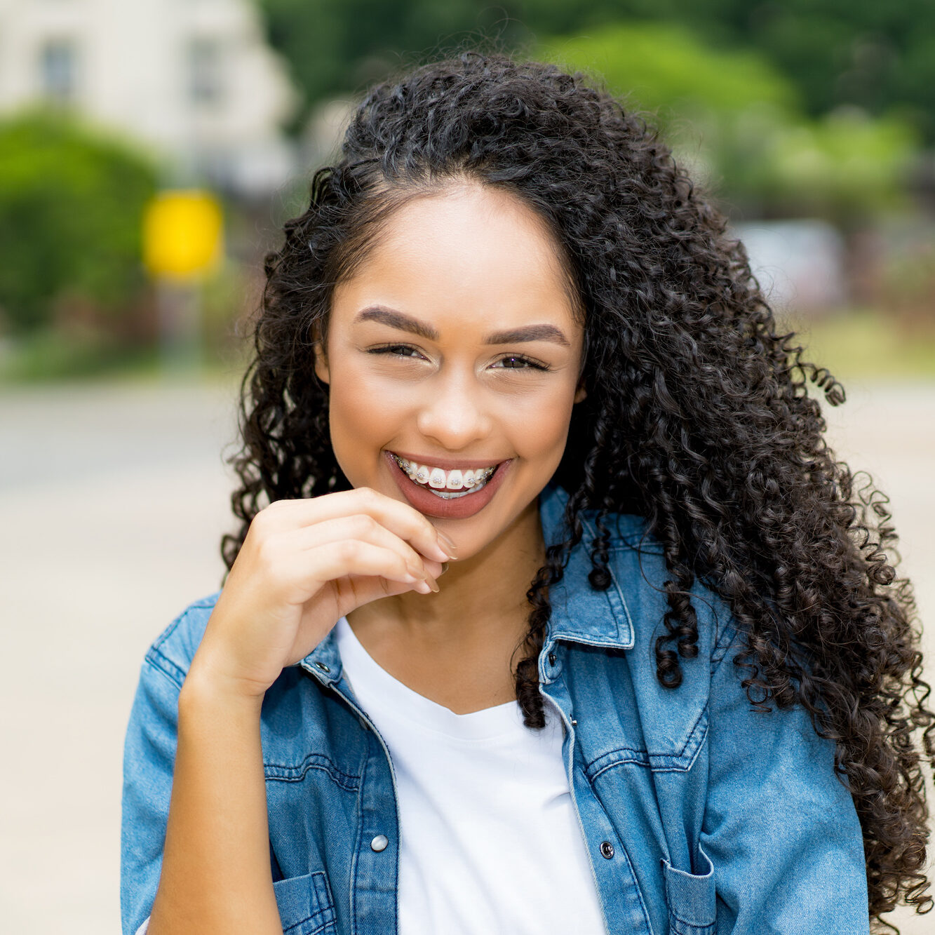 Pretty brazilian young adult woman with retainer Clear Braces