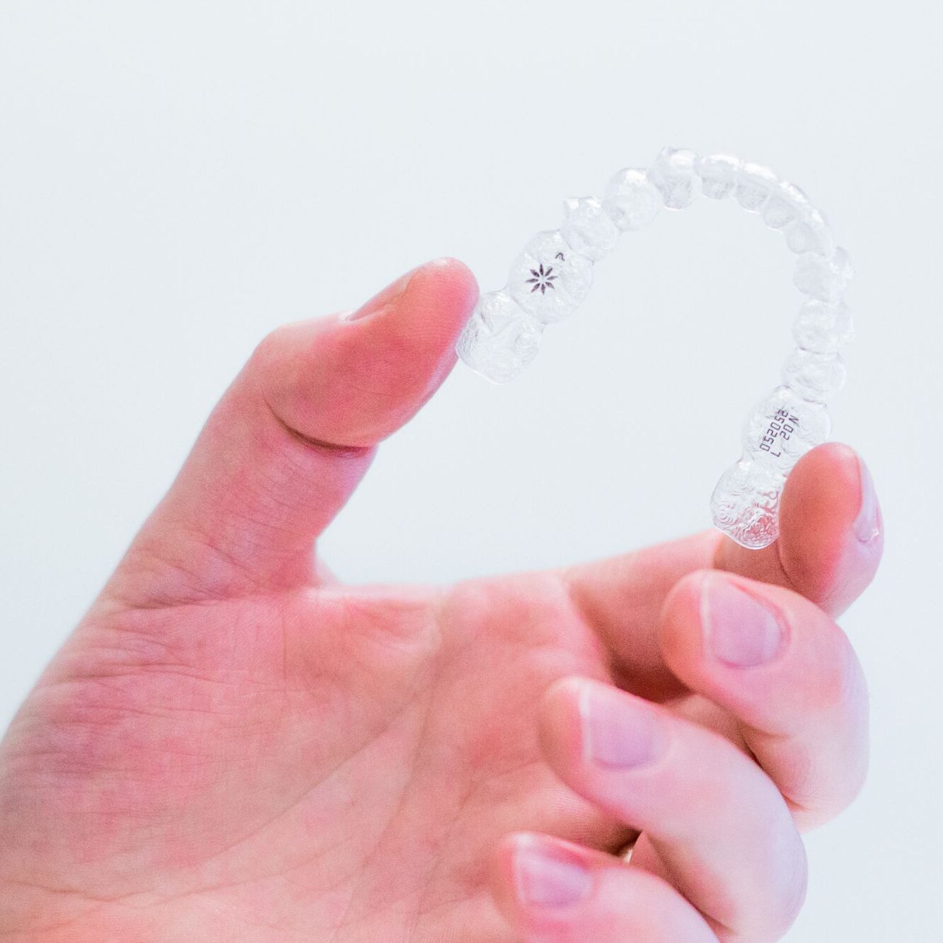 hand-holding-invisalign-aligners Contact Us